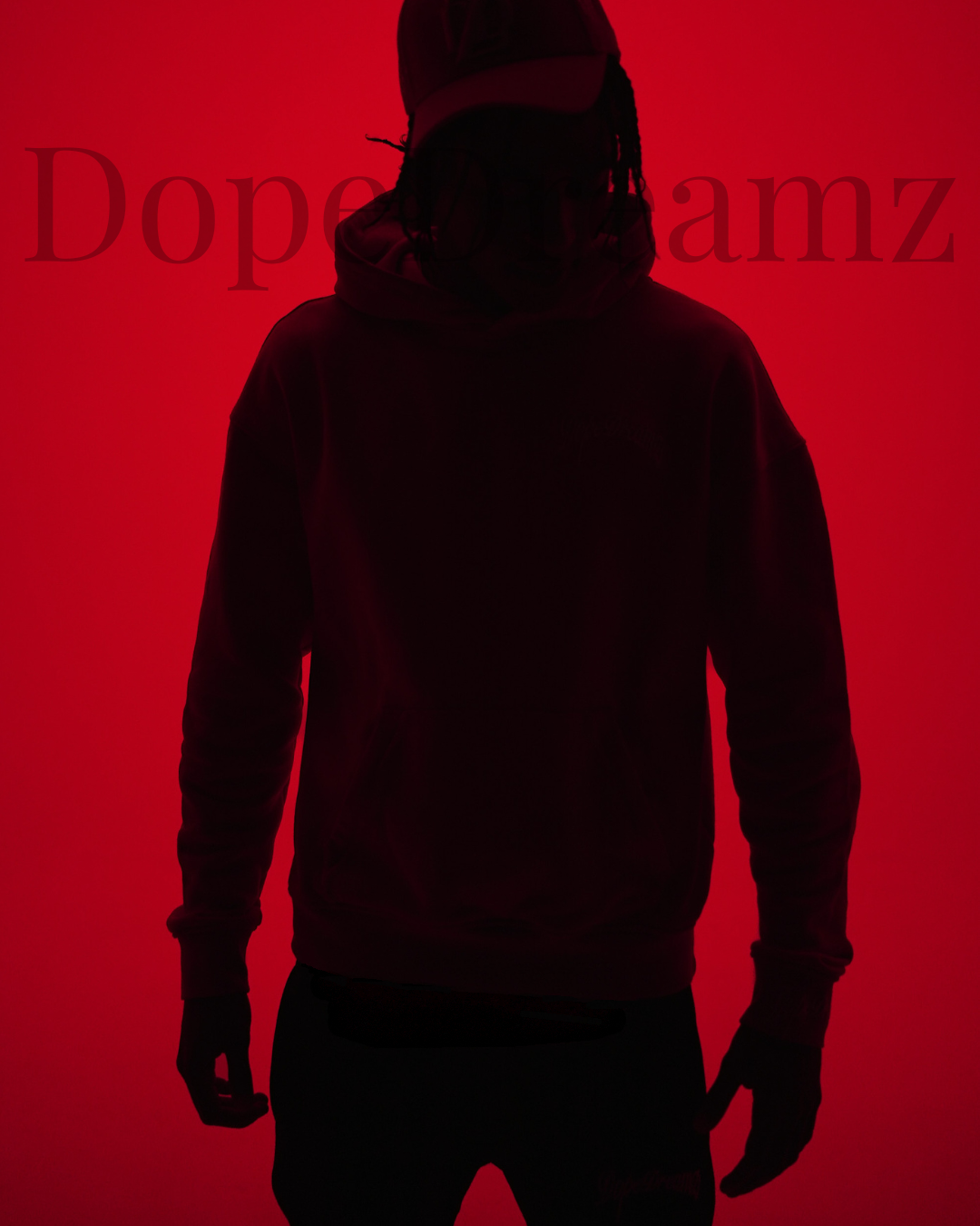 Silhouette of a person standing against a red back ground, representing strength, resilience and pressure.  