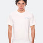 Model wearing white DopeDreamz t-shirt with blue 3D embroidered chest logo, front view

