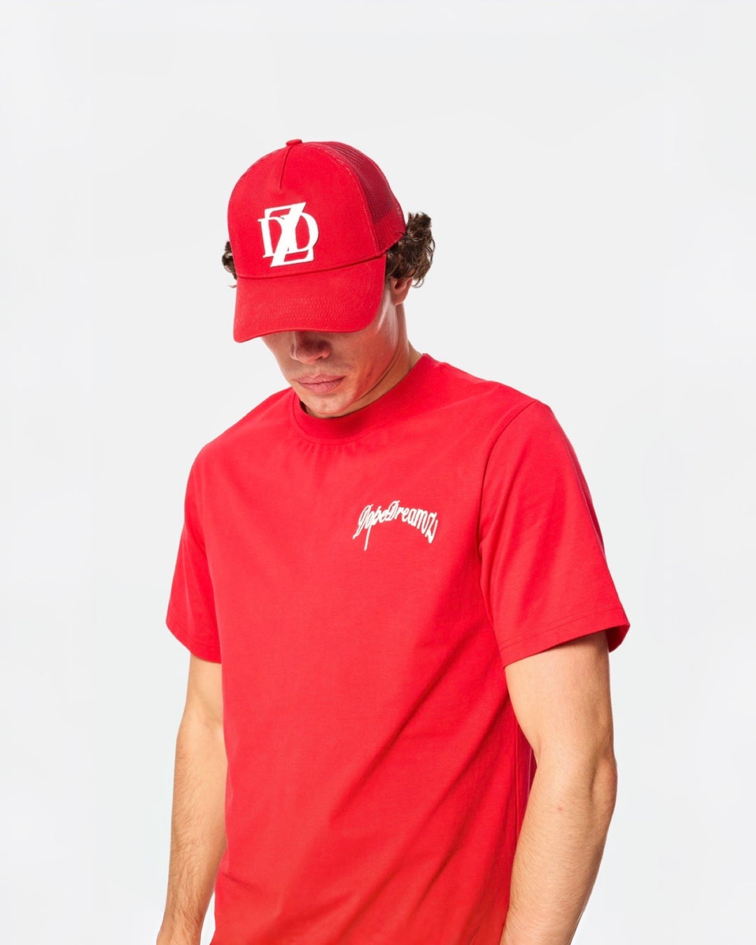 Red DopeDreamz t-shirt styled with matching red DopeDreamz cap on white background
