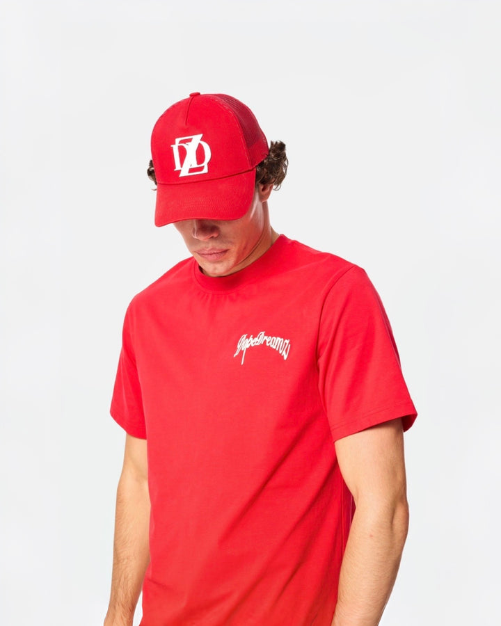 Red DopeDreamz t-shirt styled with matching red DopeDreamz cap on white background
