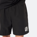Close-up of the DopeDreamz Interlude Noir black premium shorts featuring the white embroidered DDZ logo.