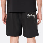 Close-up back view of the DopeDreamz Interlude Noir black premium shorts featuring the white embroidered DopeDreamz back pocket graphic.