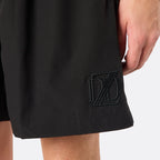 Detail close-up of the DopeDreamz Interlude Noir black shorts showcasing the premium tonal black embroidered DDZ monogram, finished with clean stitching and a minimalist design.