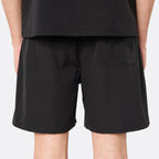 Rear view of the DopeDreamz Interlude Noir black shorts showcasing the tonal embroidered DopeDreamz script logo on the back pocket, finished with a tonal DDZ metal button closure.