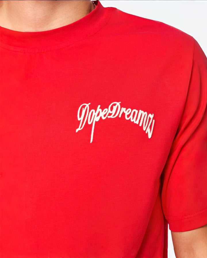 White 3D embroidered DopeDreamz logo on red t-shirt fabric