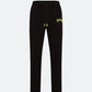 Black joggers with neon 3D embroidered logo on the front against a light background
