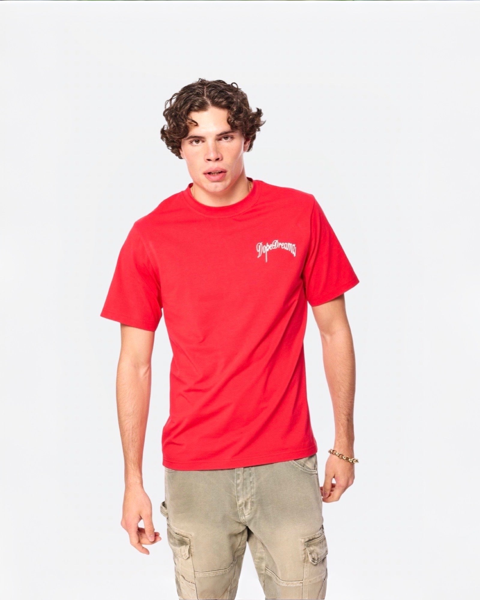Model wearing a red DopeDreamz t-shirt with white 3D embroidered logo on a white background
