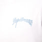 Close-up of blue 3D embroidered DopeDreamz logo on white t-shirt
