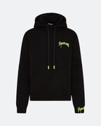 Black hoodie with neon 3D embroidered logo on the chest against a light background

