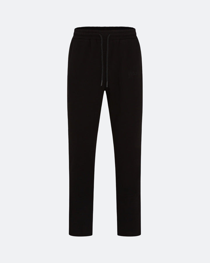 Black joggers with adjustable drawstring waist and subtle 3D embroidered logo on a light grey background
