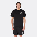 Male model wearing the DopeDreamz Interlude Noir black premium T-shirt with white DDZ chest logo and black shorts with white DDZ logo, close-up front view.