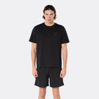 Male model wearing the DopeDreamz Interlude Noir black premium T-shirt with tonal black DDZ chest logo and black shorts with tonal black DDZ logo, close-up front view.