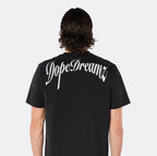 Close-up back view of the DopeDreamz Interlude Noir black premium T-shirt featuring the white DopeDreamz back graphic.
