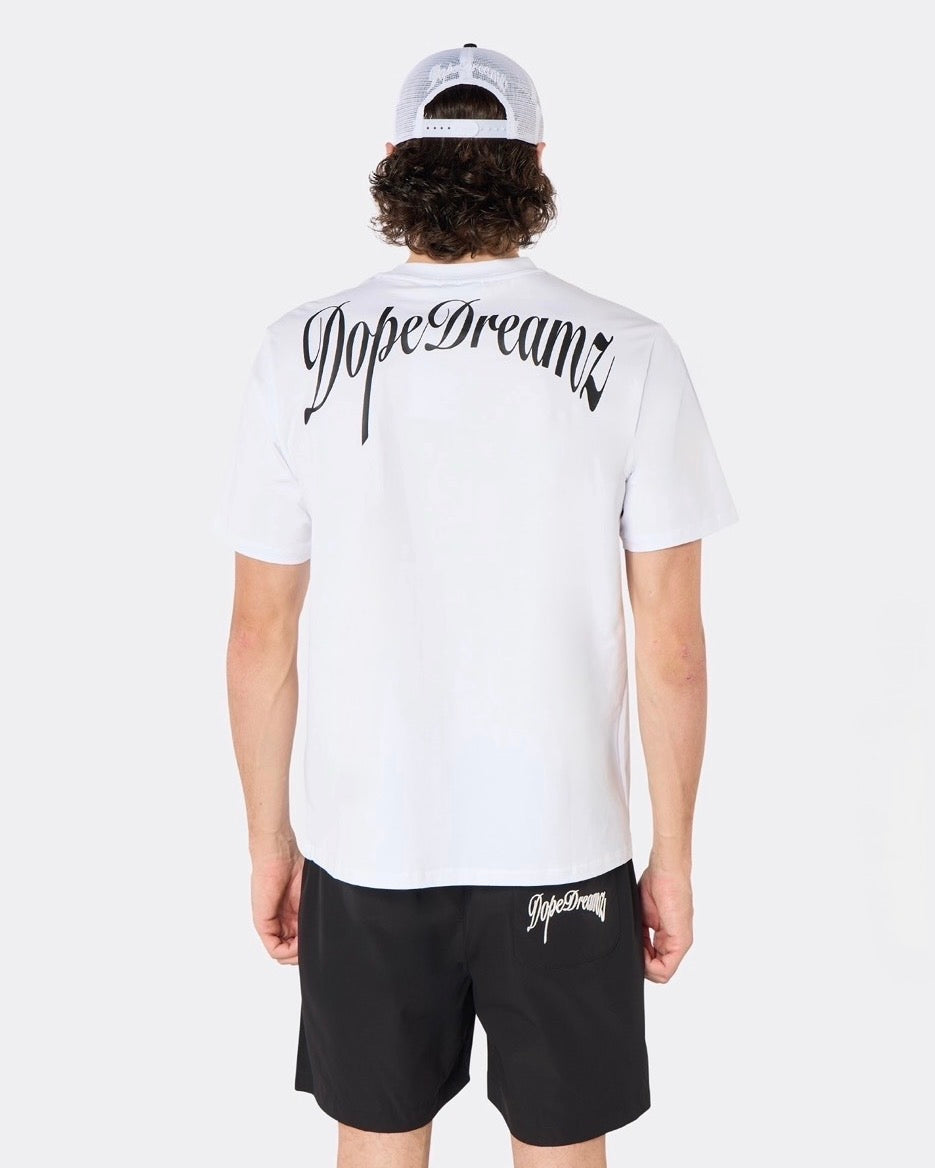 Male model wearing the DopeDreamz Interlude Noir white premium T-shirt with black DopeDreamz back graphic and black shorts with white DopeDreamz logo, back view.