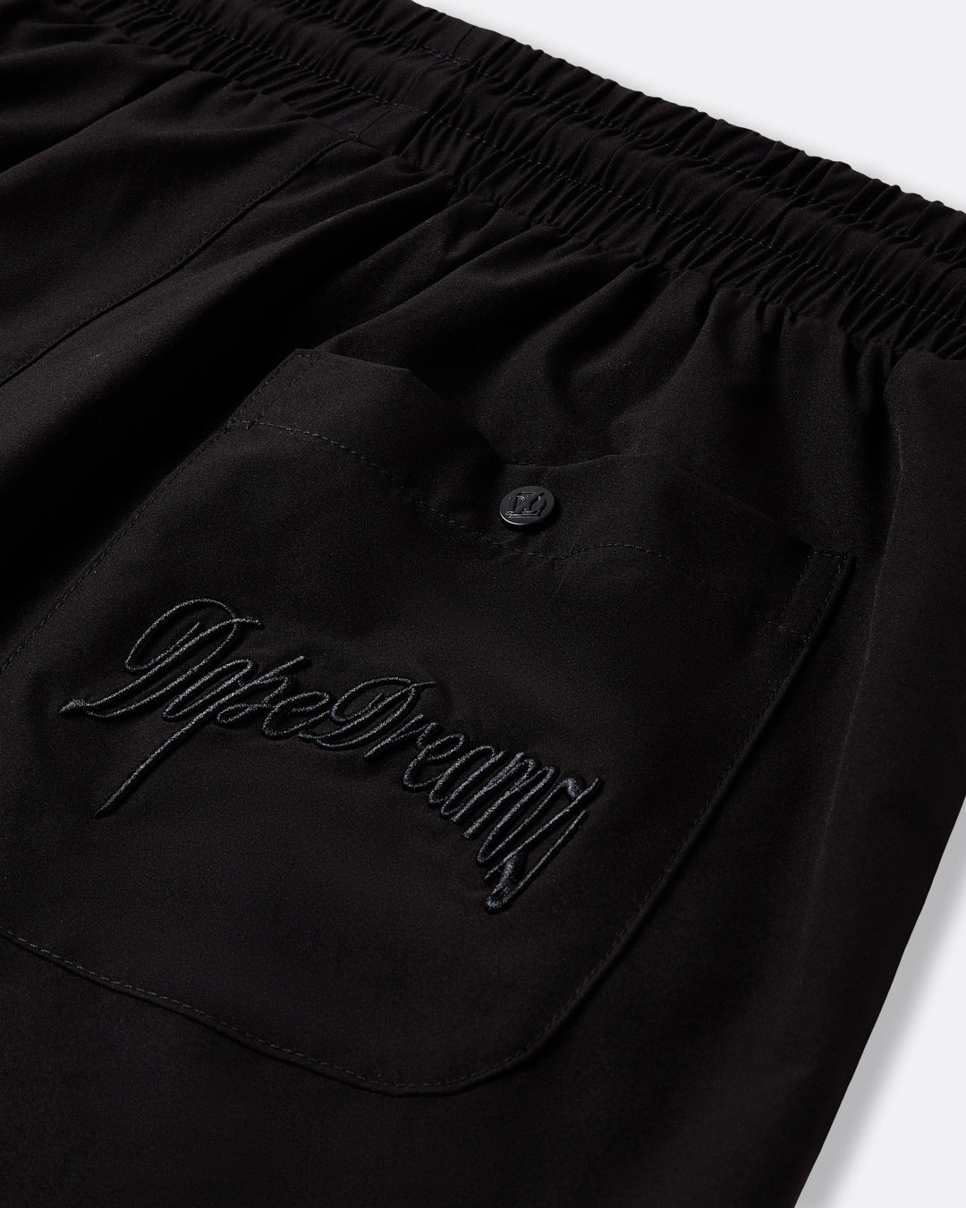 Black DopeDreamz Interlude Noir shorts detail of back pocket with embroidered DopeDreamz logo and branded button