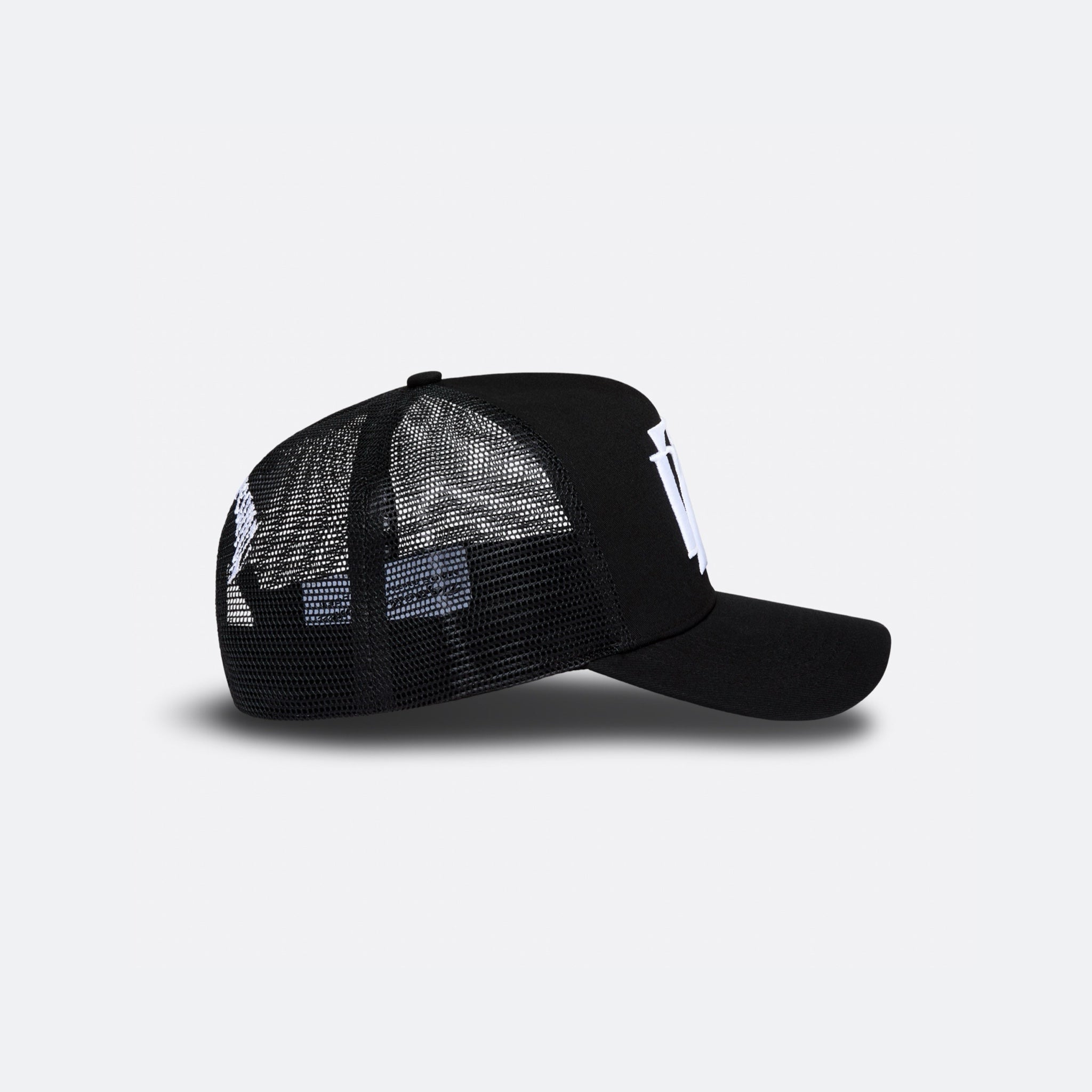 Black DopeDreamz Interlude Noir trucker cap side view with black mesh panels